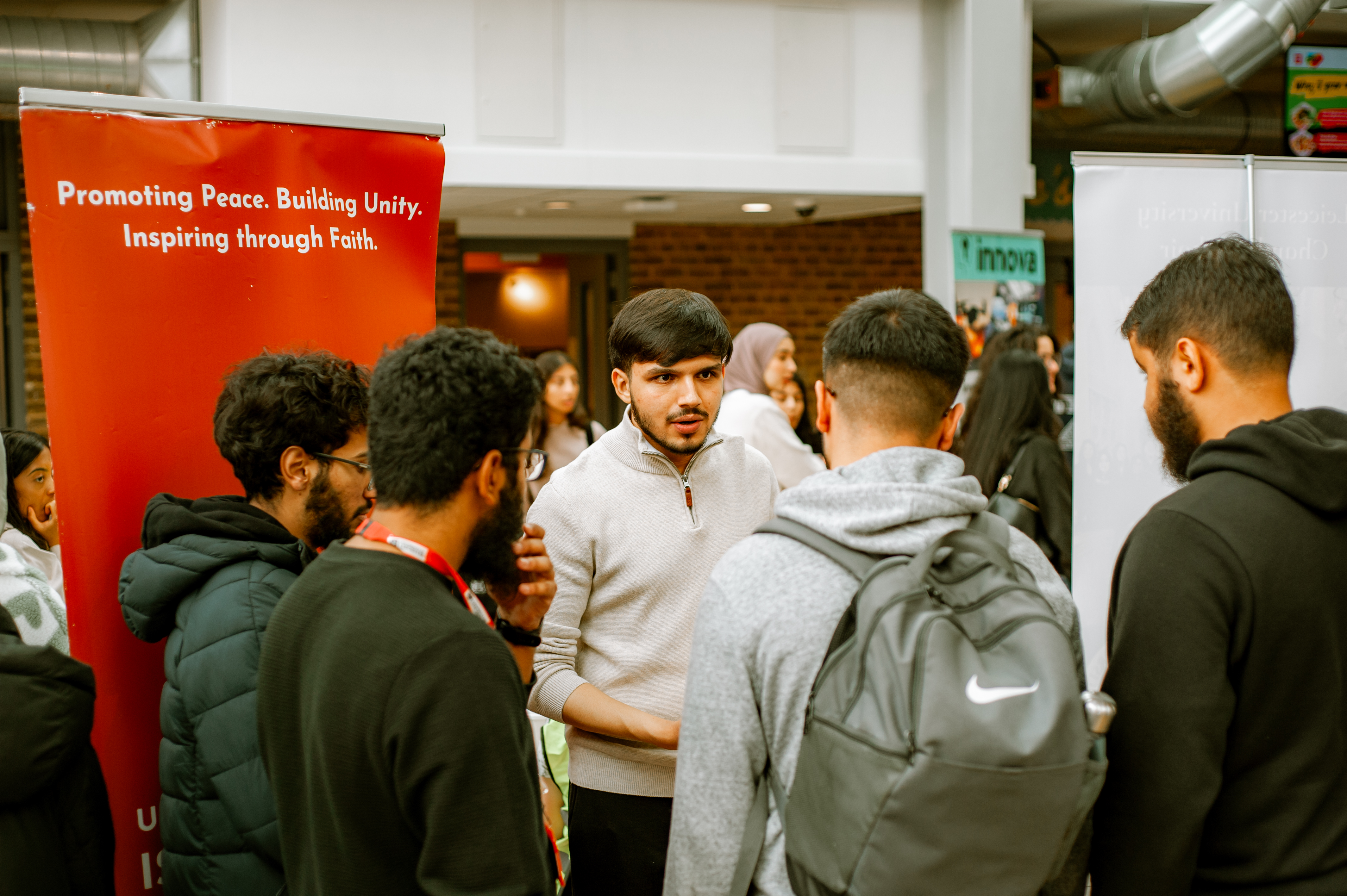 Photo of stallholder talking to group of students