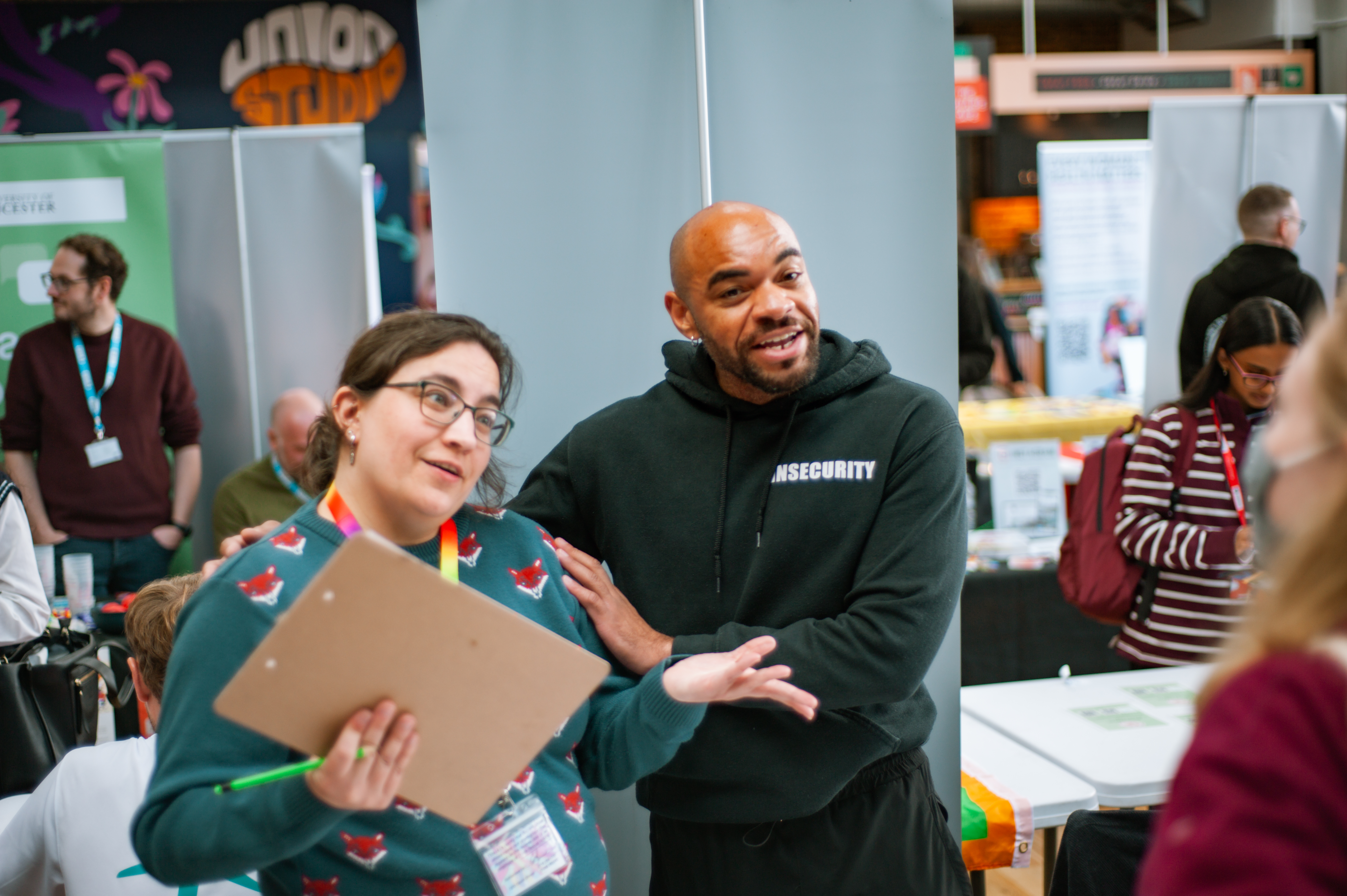 Two stallholders look friendly and ready to talk