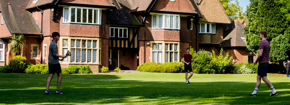 Three people playing garden games on the Village grounds