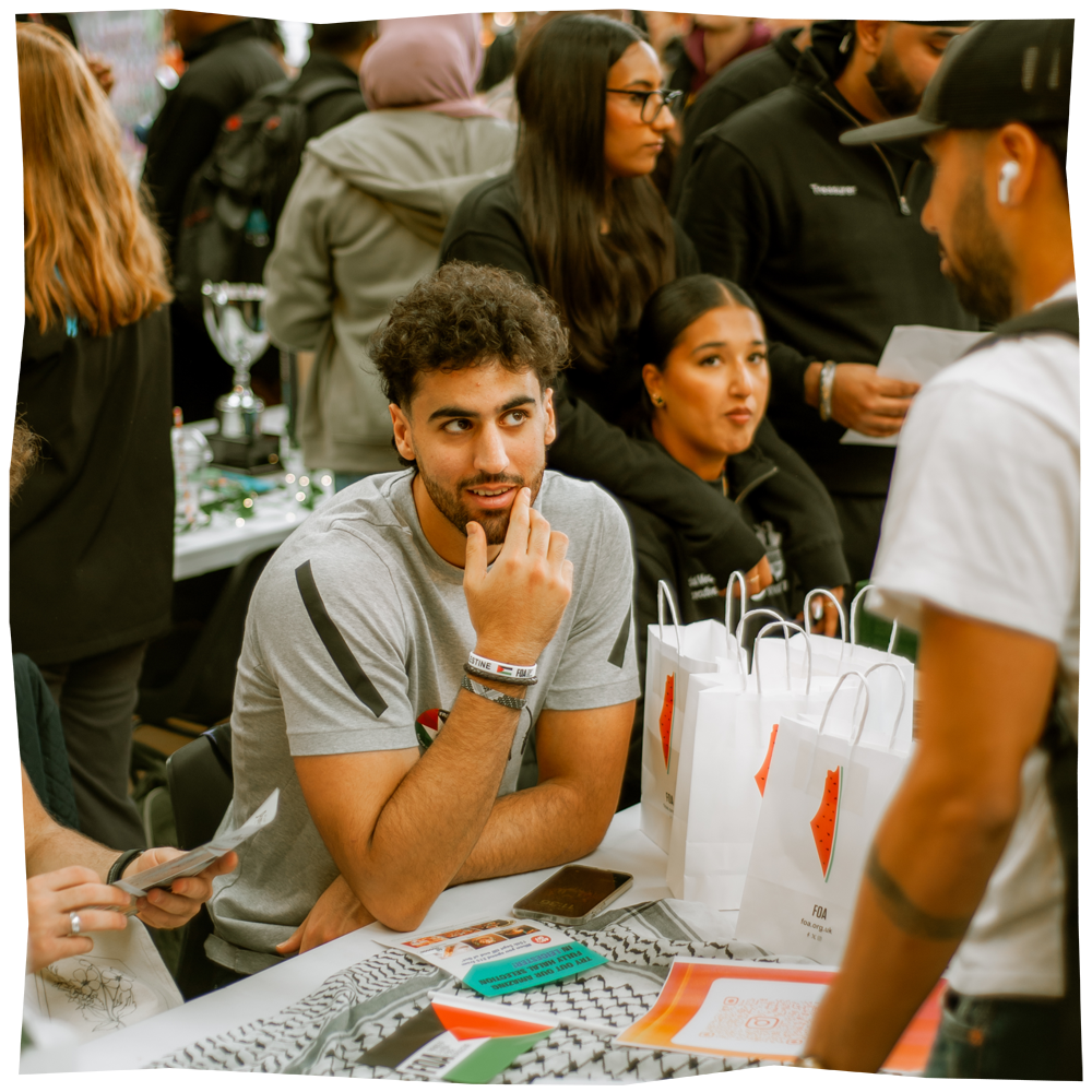 Photo of student sat at a stall