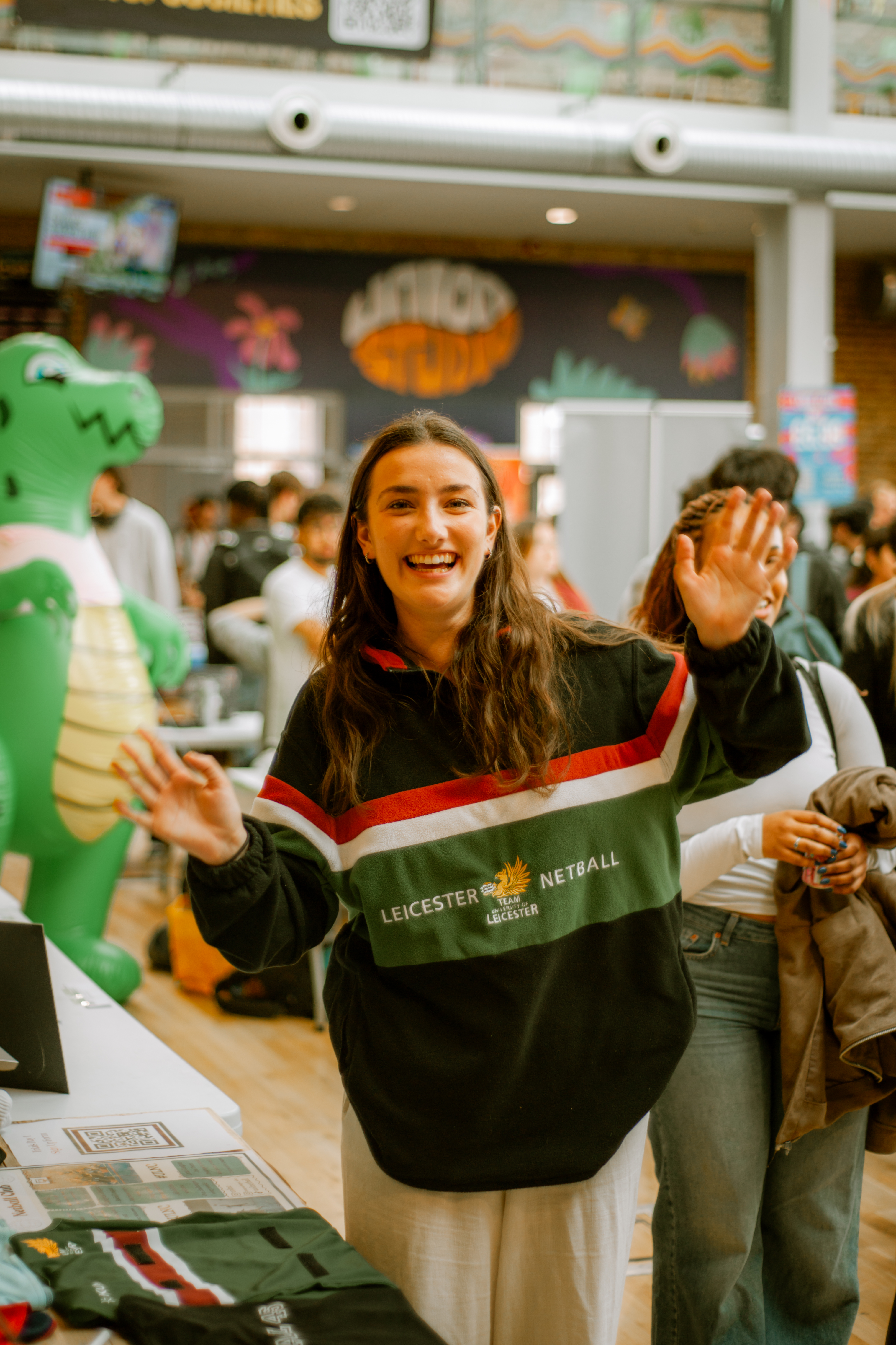 Photo of student in Leicester Sports kit smiling at the camera