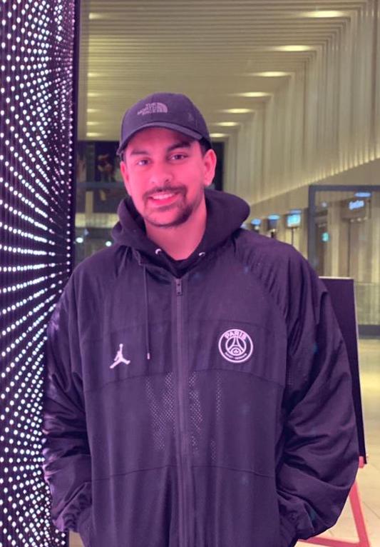 Hamza, a man in a cap and hoodie