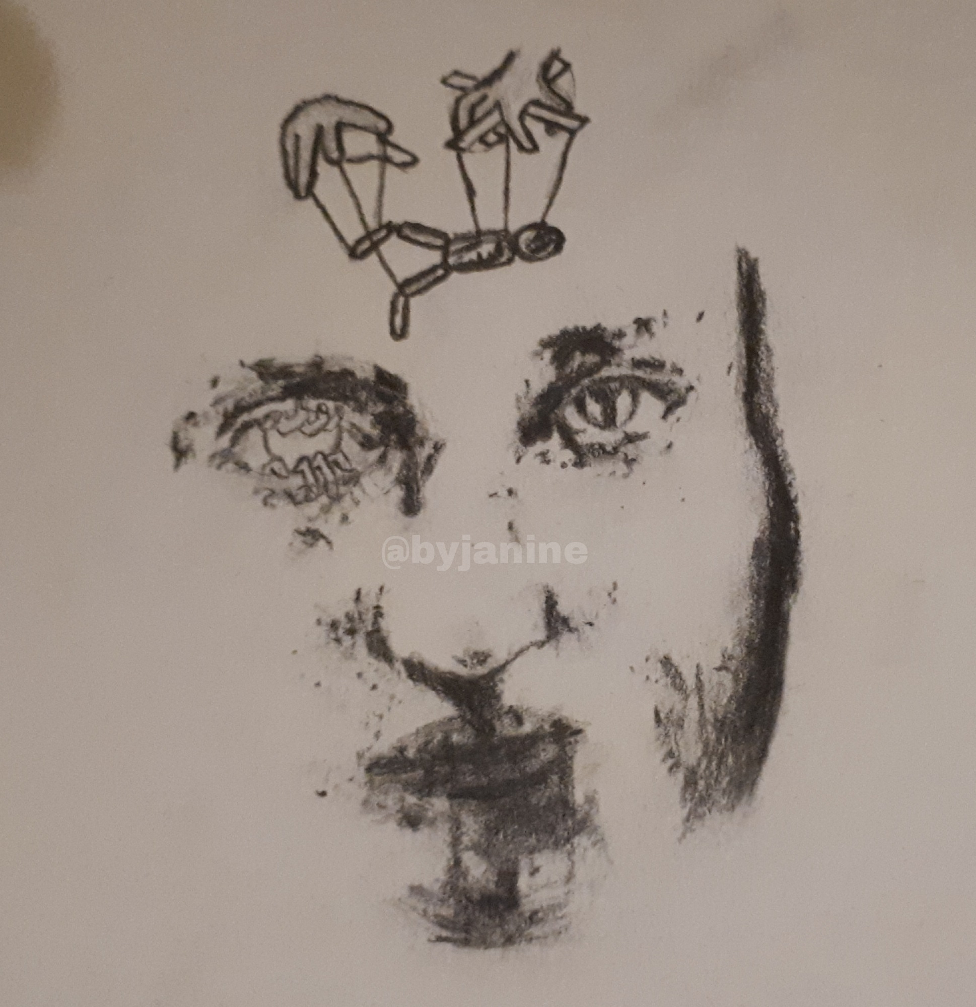 charchoal drawing of a face with a marionette puppet above
