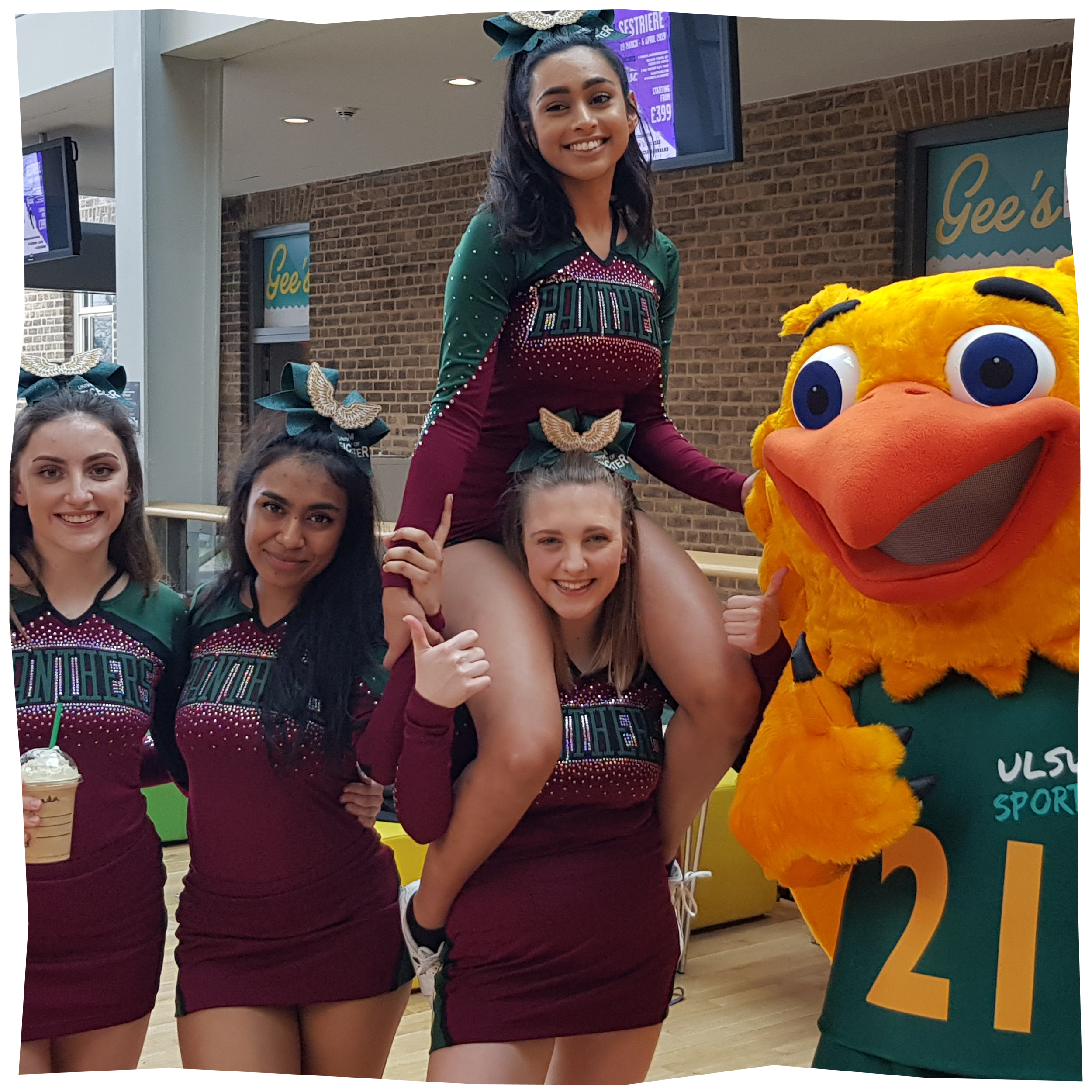 4 cheerleaders standing next to Gary the Griffin, The sports mascot