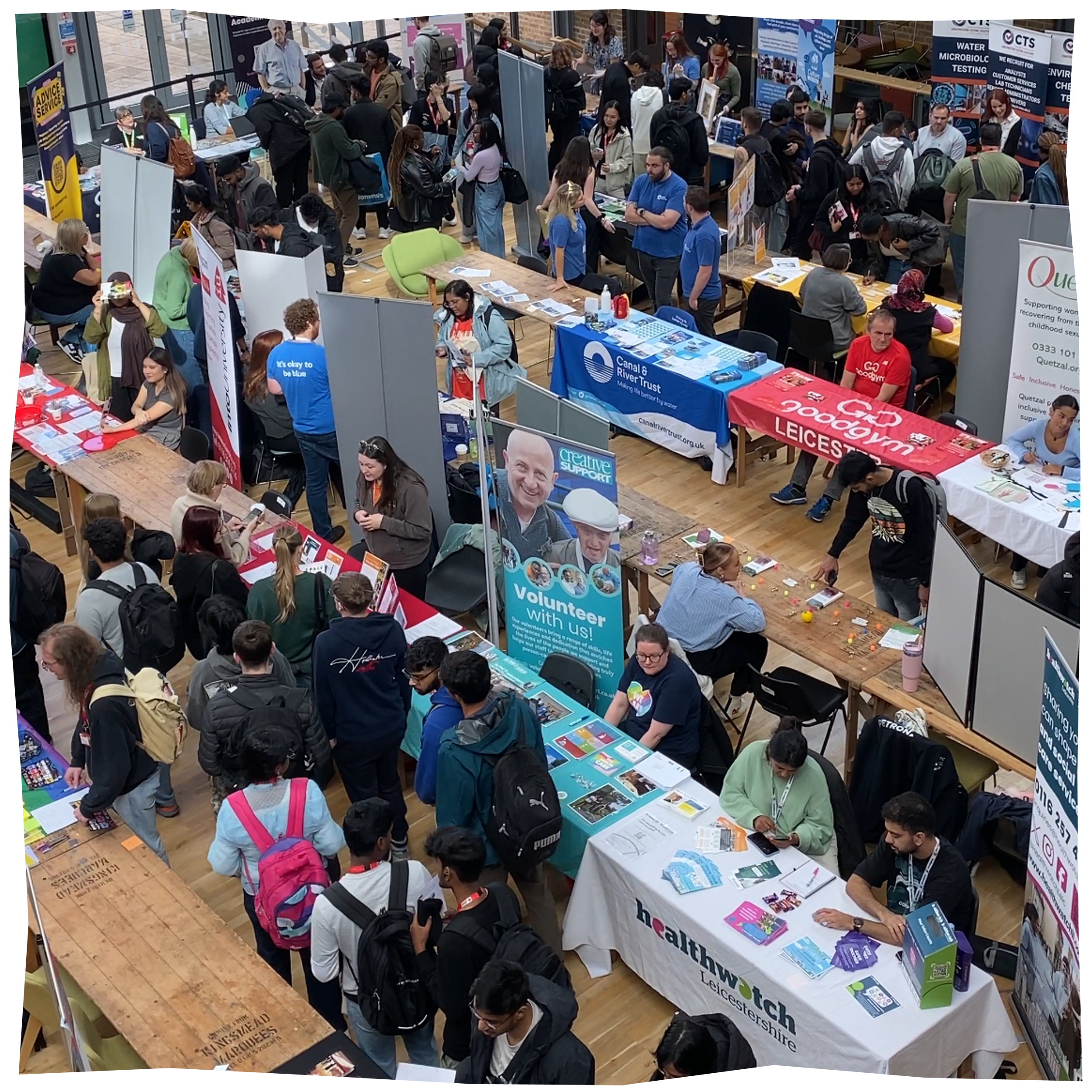 Beyond Freshers Fair, a collection of different stalls with people around interacting with them