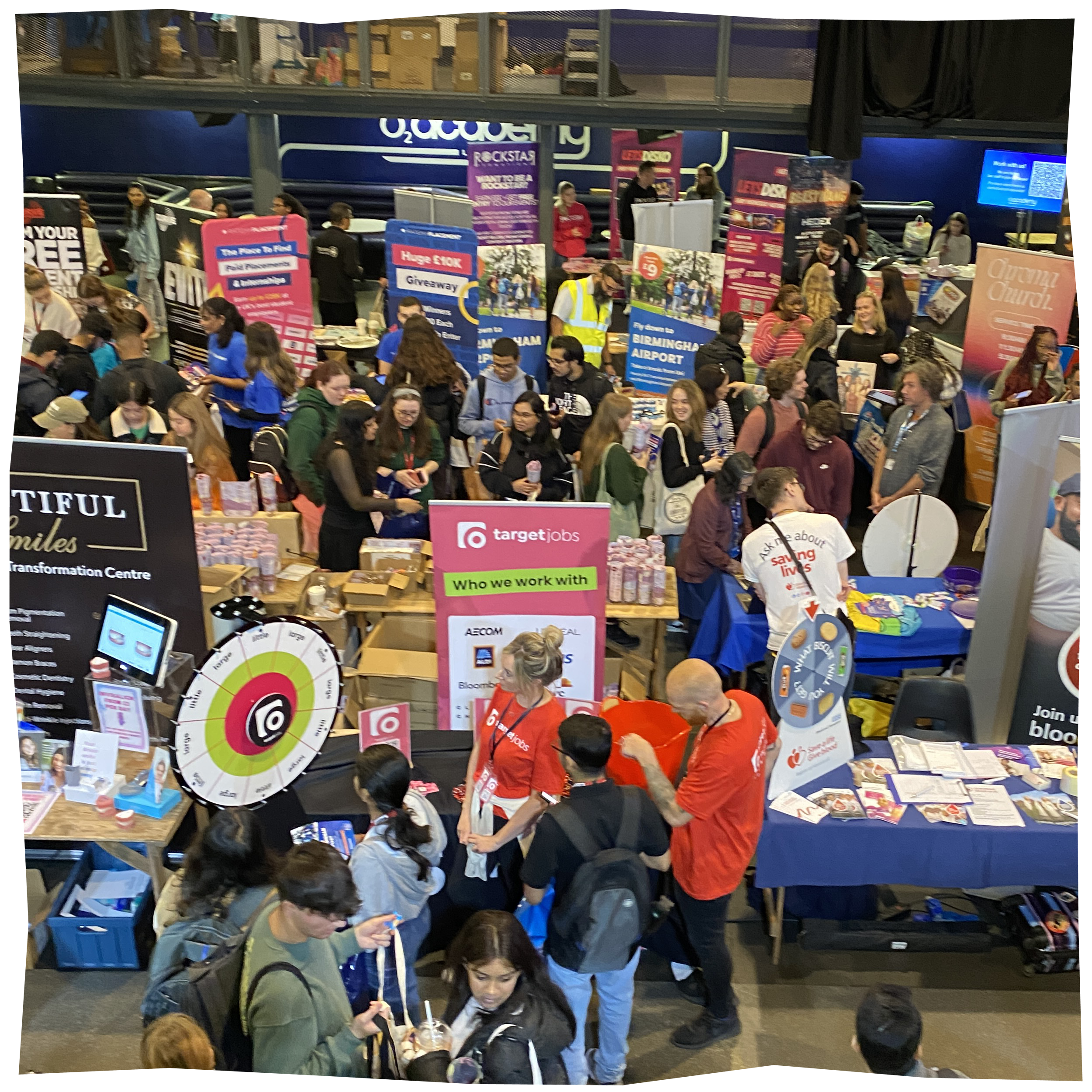 Freshers fair, showing a collection of stalls from various vendors, with lots of people looking at them