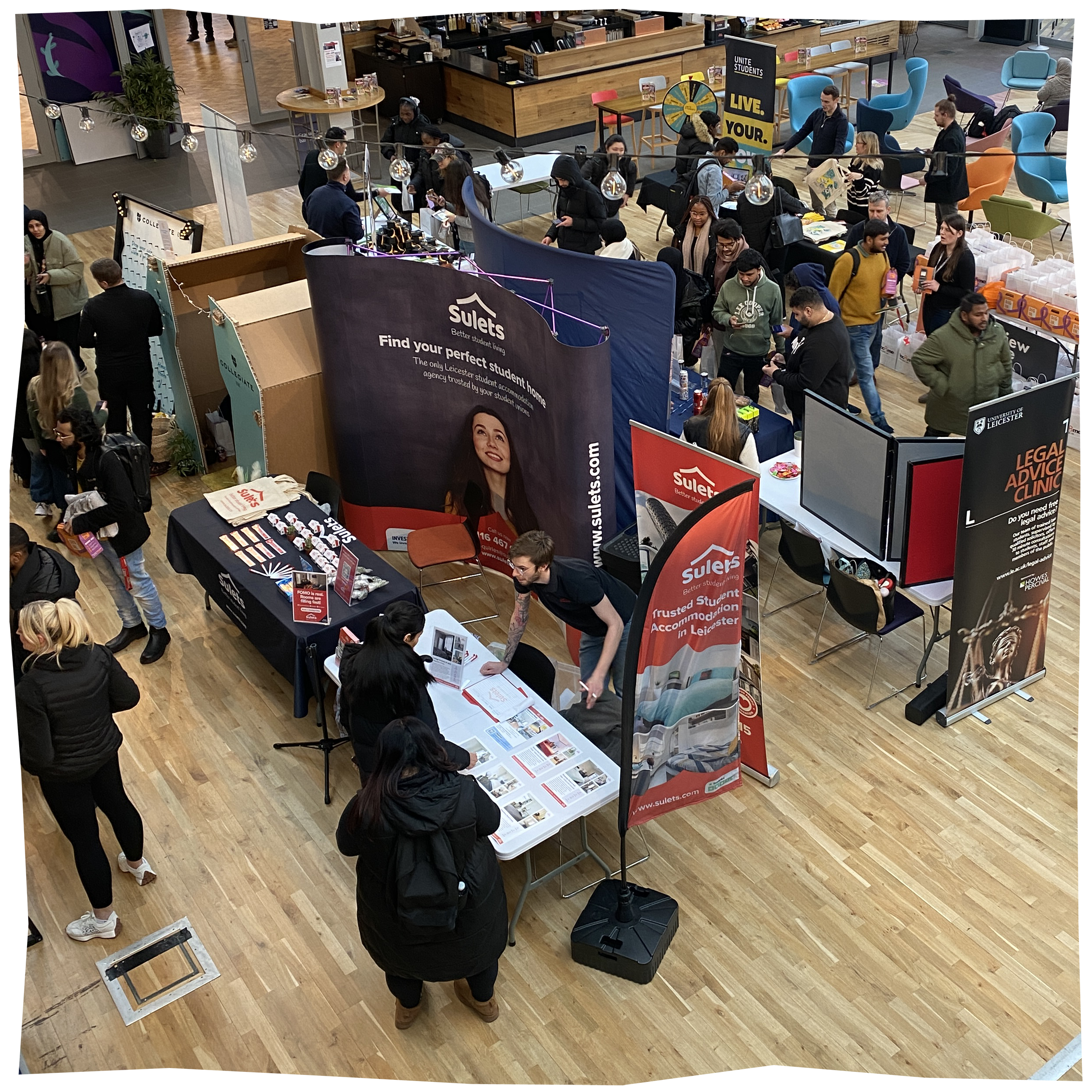 Housing Fair, with stalls from housing providers and students walking round interacting with them