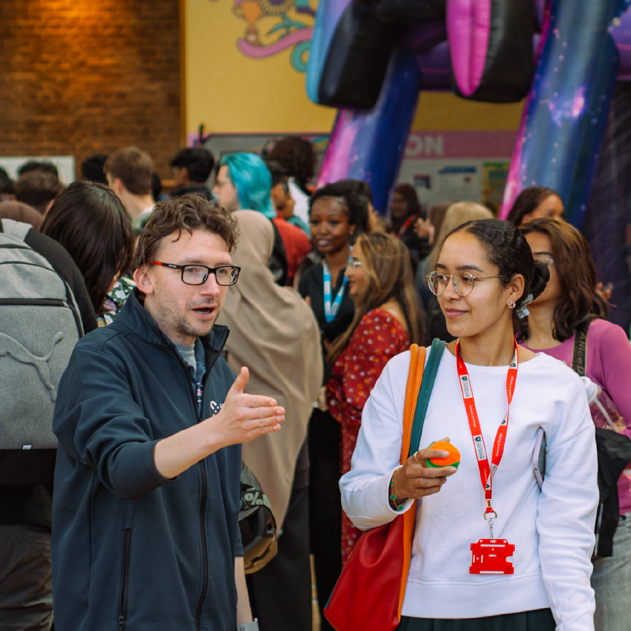 Male staff member talking to a student
