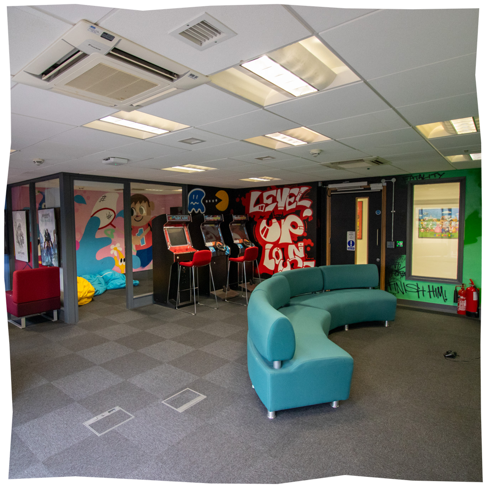 Level up Lounge, showing retro arcade consoles and large sofa