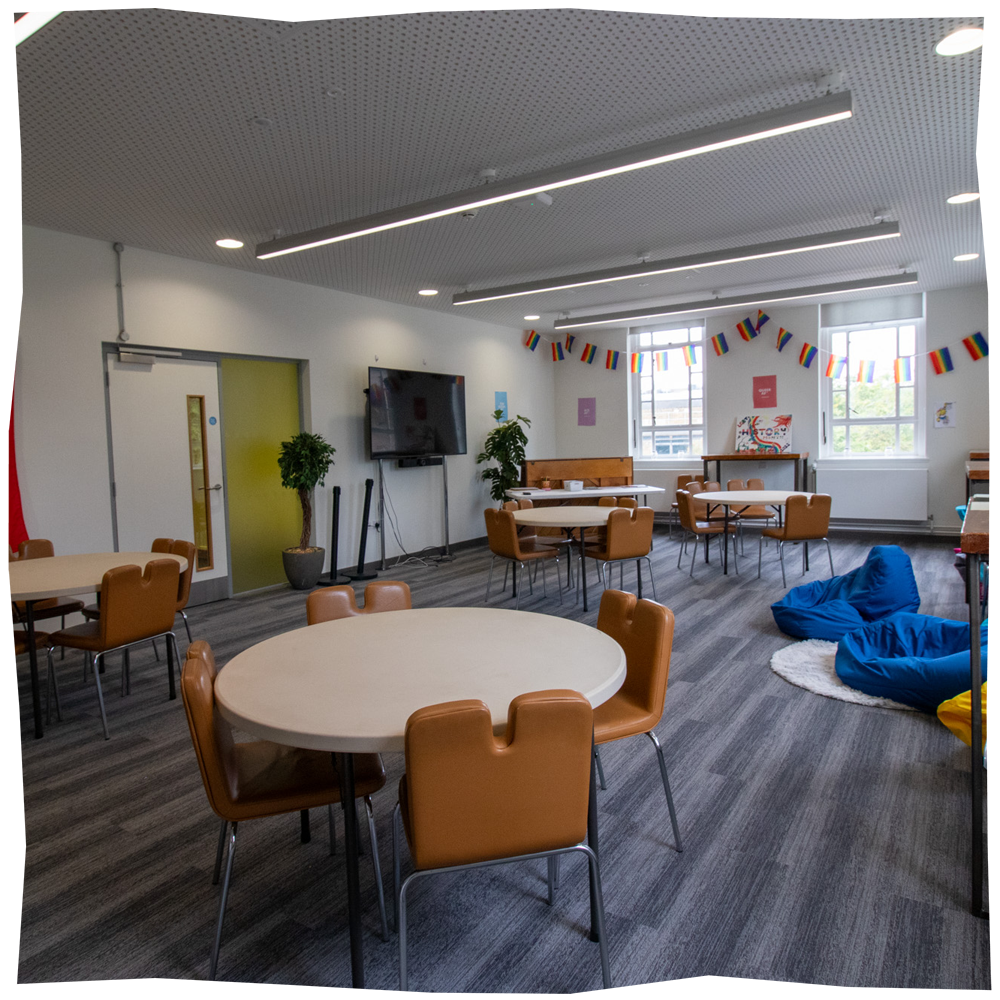 Liberation Space, a space feating round tables and chairs with some beanbags